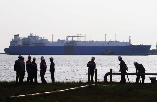 Coming to port: Workers wait for the cargo ship Towuti, carrying 119,000 cubic meters of liquified natural gas (LNG) from Tangguh, West Papua, to moor at the Arun storage and regasification facility in Lhokseumawe, Aceh, on Jan. 19, 2015. (Antara/Akbar Nugroho Gumay)